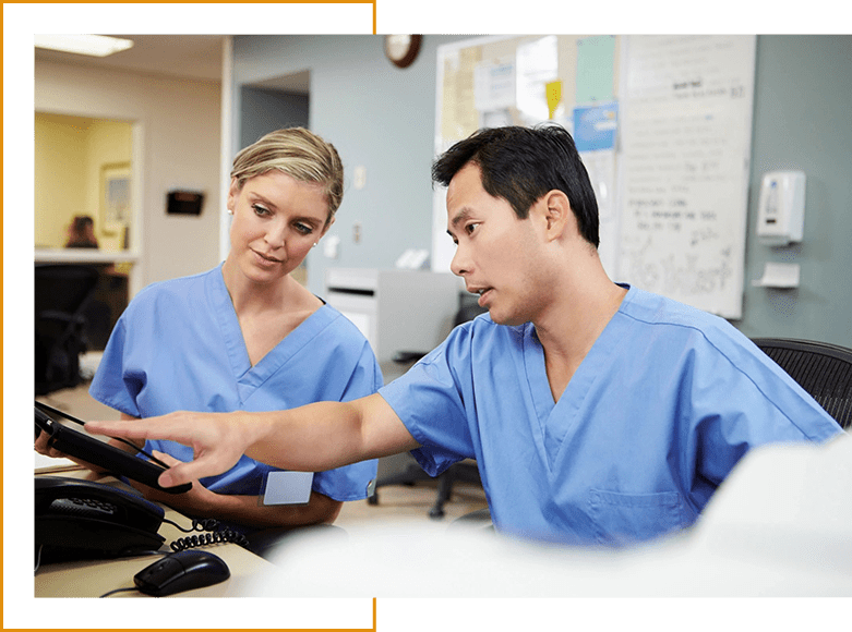 Two doctors are working together on a tablet.