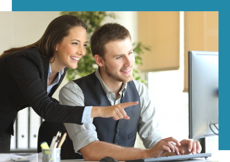 A man and woman are looking at the computer screen.