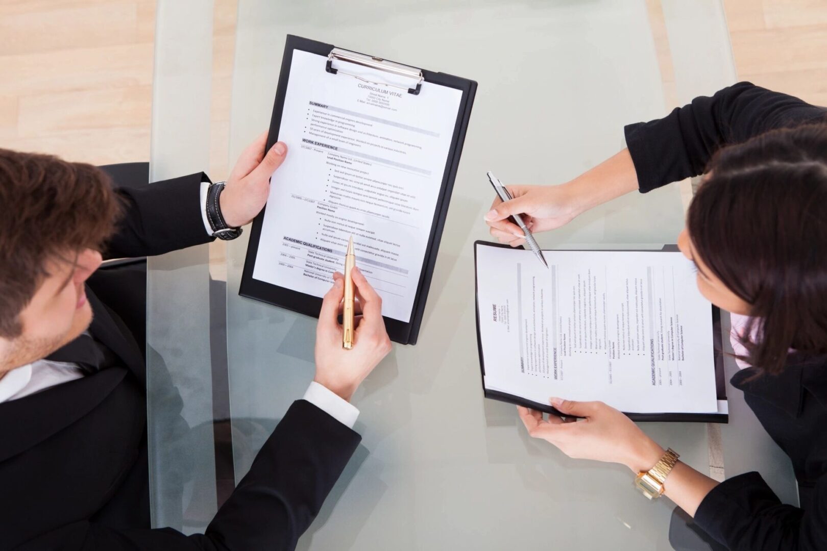 A group of people sitting around a table with papers.